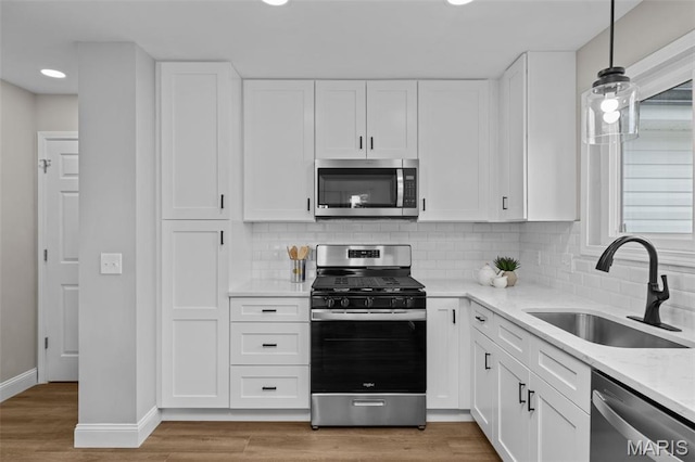 145 Aspencade Cir, Saint Peters, MO 63376 - kitchen featuring stainless steel appliances, white cabinets, backsplash, recessed lighting, and light stone countertops