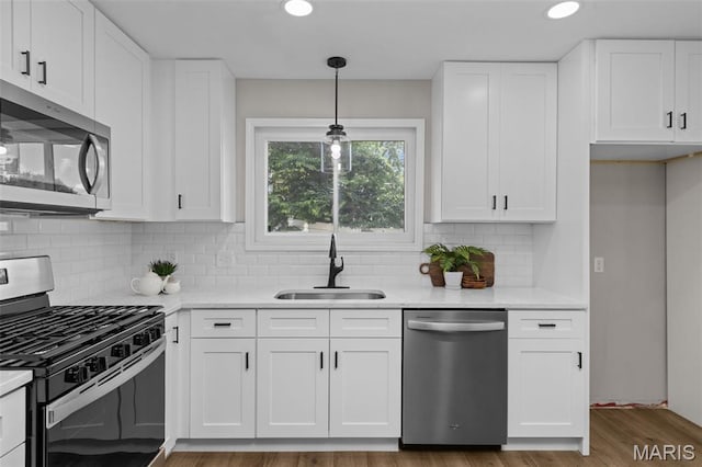 145 Aspencade Cir, Saint Peters, MO 63376 - kitchen with appliances with stainless steel finishes, white cabinets, tasteful backsplash, pendant lighting, and recessed lighting