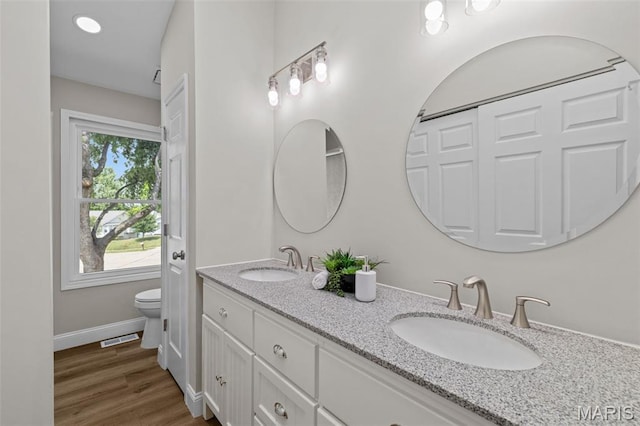 145 Aspencade Cir, Saint Peters, MO 63376 - bathroom featuring double vanity and wood finished floors