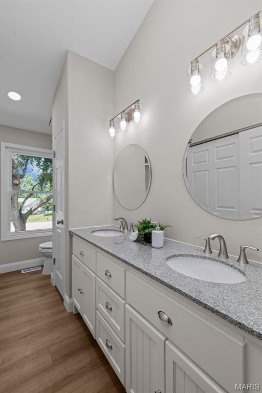 145 Aspencade Cir, Saint Peters, MO 63376 - bathroom featuring double vanity and wood finished floors