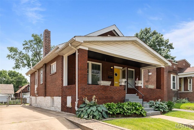 5524 Devonshire Ave, Saint Louis, MO 63109 - bungalow-style house featuring a chimney and brick siding
