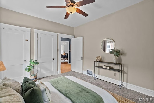 5524 Devonshire Ave, Saint Louis, MO 63109 - bedroom featuring light colored carpet, ceiling fan, and a chandelier