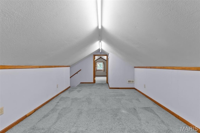 5524 Devonshire Ave, Saint Louis, MO 63109 - bonus room with a textured ceiling, carpet flooring, and lofted ceiling