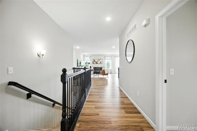 213 Dell View Dr, Arnold, MO 63010 - hallway featuring wood finished floors, recessed lighting, and an upstairs landing