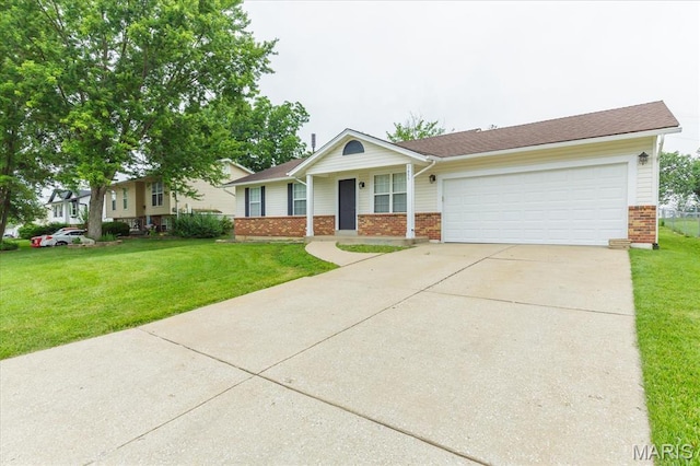 1655 Oakwood Dr, Ofallon, MO 63366 - single story home with brick siding, an attached garage, concrete driveway, and a front yard