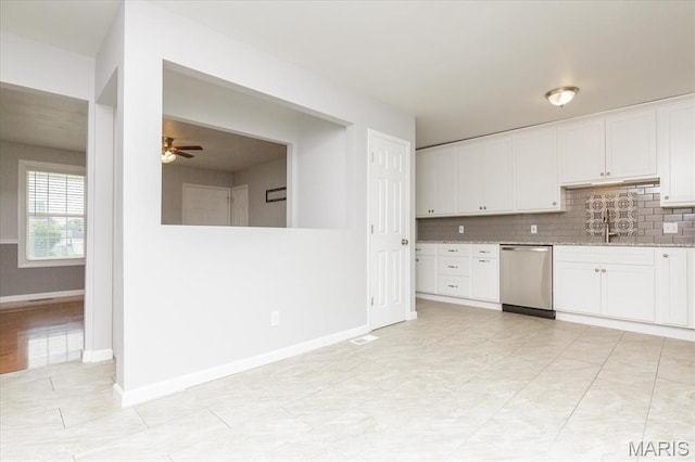 1655 Oakwood Dr, Ofallon, MO 63366 - kitchen featuring stainless steel dishwasher, a ceiling fan, backsplash, white cabinets, and light stone counters
