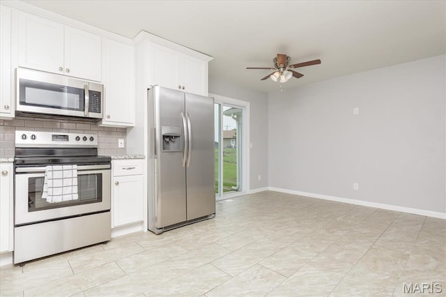 1655 Oakwood Dr, Ofallon, MO 63366 - kitchen with stainless steel appliances, ceiling fan, white cabinets, decorative backsplash, and light stone counters