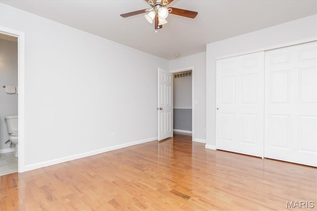 1655 Oakwood Dr, Ofallon, MO 63366 - unfurnished bedroom featuring light wood-style flooring, a closet, ensuite bath, and ceiling fan