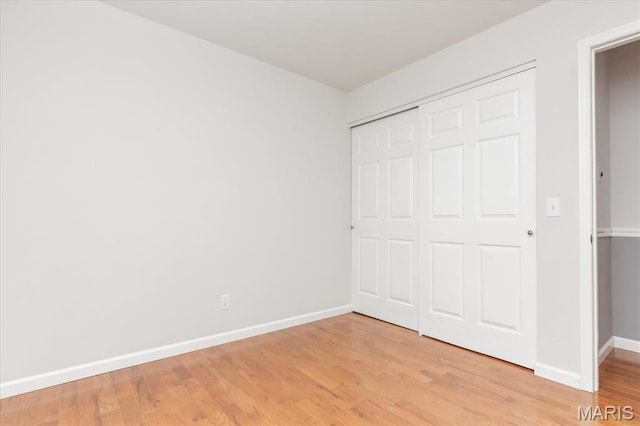 1655 Oakwood Dr, Ofallon, MO 63366 - unfurnished bedroom featuring light wood-style flooring and a closet