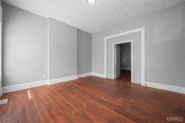 3921 Pennsylvania Ave, Saint Louis, MO 63118 - empty room featuring wood finished floors and a textured ceiling