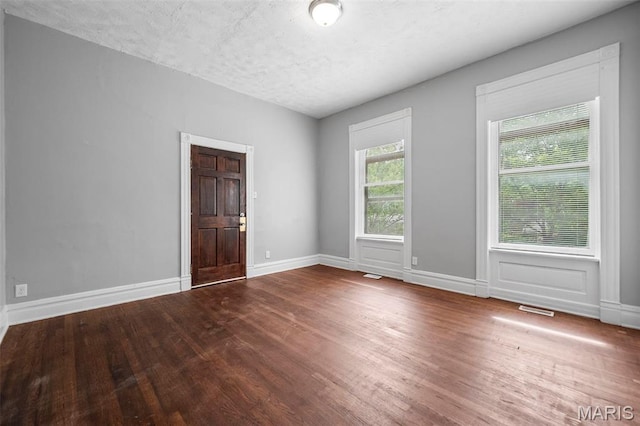 3921 Pennsylvania Ave, Saint Louis, MO 63118 - spare room with wood finished floors and a textured ceiling