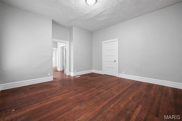 3921 Pennsylvania Ave, Saint Louis, MO 63118 - spare room with dark wood-type flooring and baseboards