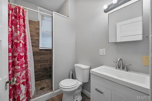 3921 Pennsylvania Ave, Saint Louis, MO 63118 - full bathroom with vanity, a stall shower, and wood finished floors