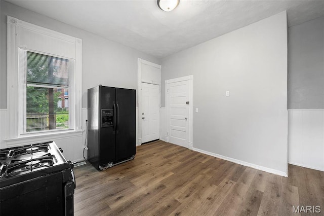 3921 Pennsylvania Ave, Saint Louis, MO 63118 - kitchen featuring black appliances, wood finished floors, and wainscoting