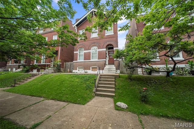 3921 Pennsylvania Ave, Saint Louis, MO 63118 - view of front facade with brick siding, a front yard, and stairs