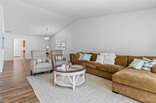 1531 Charmaine Dr, Bonne Terre, MO 63628 - living room featuring wood finished floors, lofted ceiling, and a chandelier