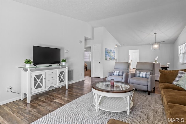 1531 Charmaine Dr, Bonne Terre, MO 63628 - living area featuring vaulted ceiling, wood finished floors, and a chandelier