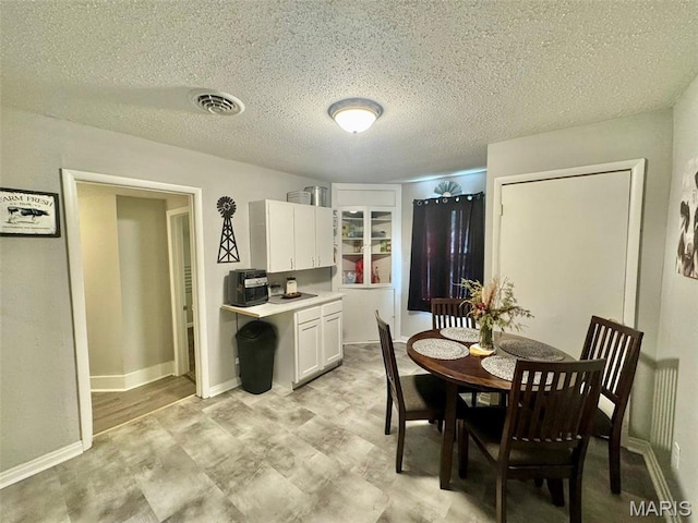 119 N Saint Charles St, Bowling Green, MO 63334 - dining area featuring a textured ceiling and light floors