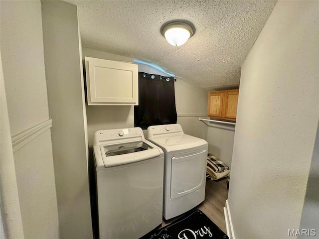 119 N Saint Charles St, Bowling Green, MO 63334 - laundry area with cabinet space, separate washer and dryer, a textured ceiling, and wood finished floors