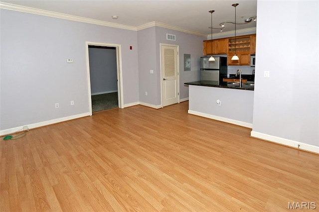 2636 S Mcknight Rd, Rock Hill, MO 63124 - unfurnished living room with light wood-type flooring and crown molding