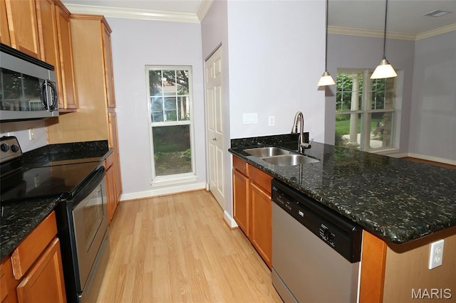 2636 S Mcknight Rd, Rock Hill, MO 63124 - kitchen featuring appliances with stainless steel finishes, light wood-style flooring, a peninsula, brown cabinets, and crown molding