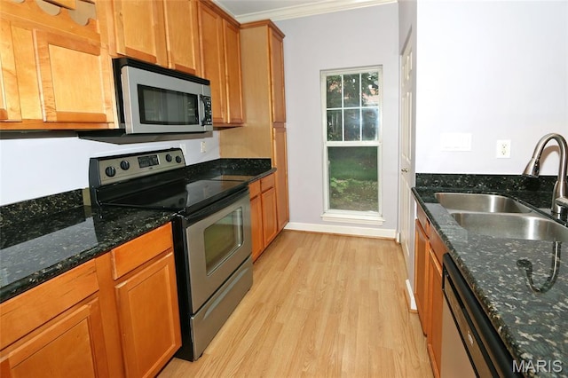 2636 S Mcknight Rd, Rock Hill, MO 63124 - kitchen featuring stainless steel appliances, light wood finished floors, crown molding, brown cabinets, and dark stone countertops