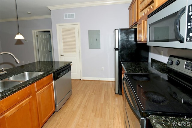 2636 S Mcknight Rd, Rock Hill, MO 63124 - kitchen with appliances with stainless steel finishes, electric panel, crown molding, brown cabinets, and light wood-type flooring
