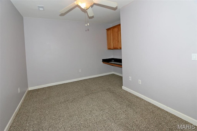 2636 S Mcknight Rd, Rock Hill, MO 63124 - spare room featuring carpet flooring, a ceiling fan, and built in study area