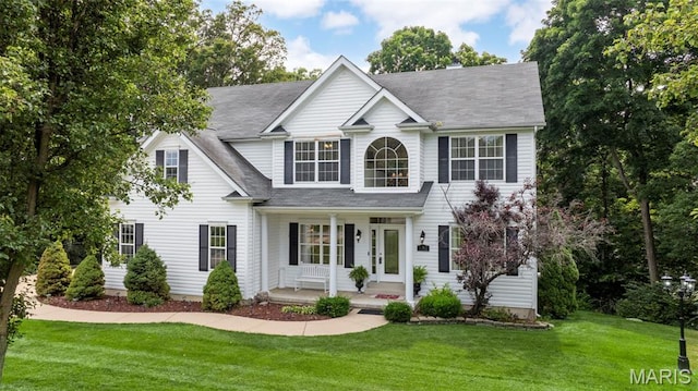 5 Hickory Glen Ct, Lake St Louis, MO 63367 - view of front facade with a porch, a front yard, and a shingled roof