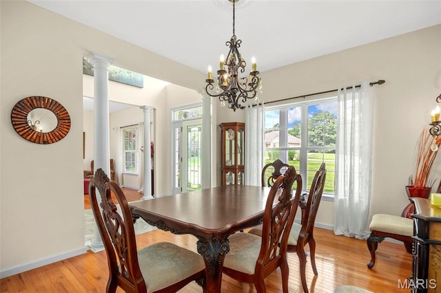 5 Hickory Glen Ct, Lake St Louis, MO 63367 - dining space with ornate columns, a chandelier, plenty of natural light, and light wood finished floors