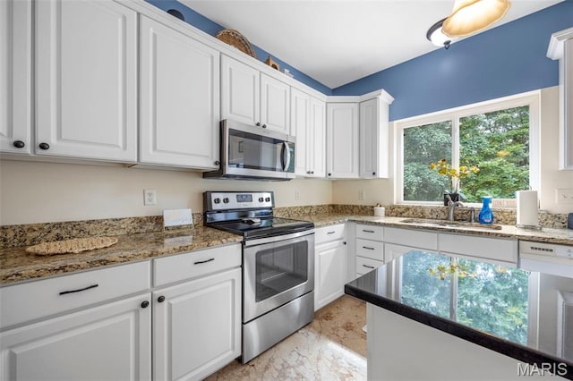 5 Hickory Glen Ct, Lake St Louis, MO 63367 - kitchen with appliances with stainless steel finishes, light marble finish flooring, white cabinetry, and stone countertops