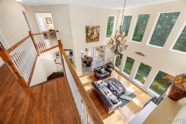 5 Hickory Glen Ct, Lake St Louis, MO 63367 - living area featuring a chandelier, wood finished floors, and a towering ceiling