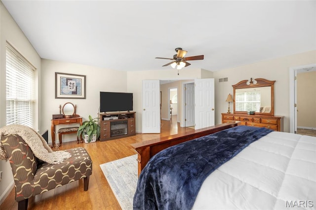 5 Hickory Glen Ct, Lake St Louis, MO 63367 - bedroom with multiple windows, wood finished floors, and a ceiling fan