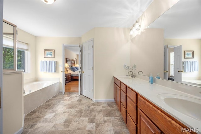 5 Hickory Glen Ct, Lake St Louis, MO 63367 - ensuite bathroom featuring a garden tub, double vanity, and stone finish flooring