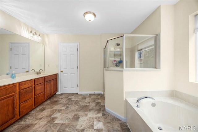 5 Hickory Glen Ct, Lake St Louis, MO 63367 - bathroom featuring vanity, a garden tub, a stall shower, stone finish floors, and healthy amount of natural light