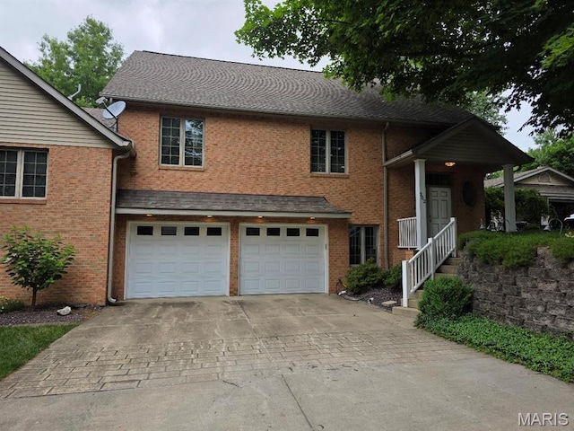 302 Lorean St, Troy, IL 62294 - view of front of property featuring concrete driveway, a garage, and brick siding