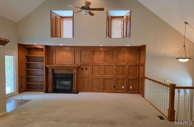 302 Lorean St, Troy, IL 62294 - unfurnished living room with high vaulted ceiling, carpet flooring, ceiling fan, a fireplace with flush hearth, and healthy amount of natural light