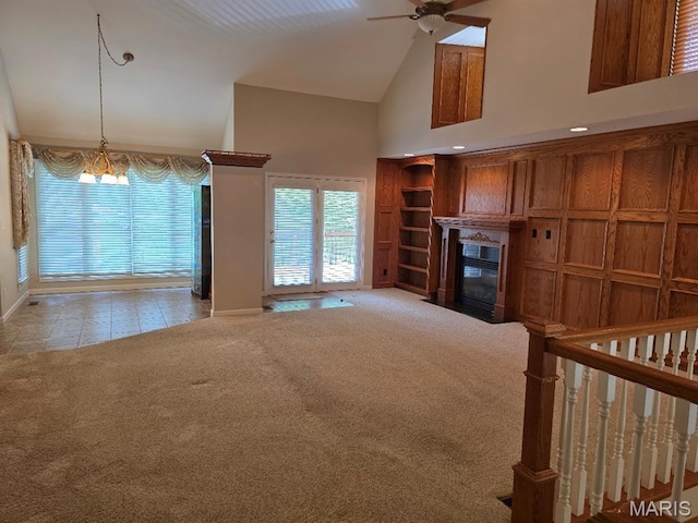 302 Lorean St, Troy, IL 62294 - unfurnished living room with high vaulted ceiling, a ceiling fan, carpet, healthy amount of natural light, and a fireplace with flush hearth