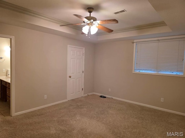 302 Lorean St, Troy, IL 62294 - unfurnished bedroom with a tray ceiling, ornamental molding, carpet flooring, connected bathroom, and ceiling fan