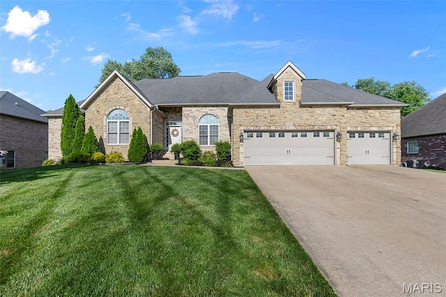 2528 Palomino Dr, Cape Girardeau, MO 63701 - french country style house with concrete driveway, stone siding, a front lawn, and an attached garage