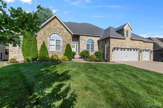 2528 Palomino Dr, Cape Girardeau, MO 63701 - french country inspired facade featuring stone siding, a front lawn, driveway, and a garage