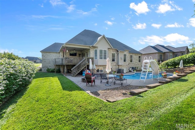 2528 Palomino Dr, Cape Girardeau, MO 63701 - rear view of property featuring stairway, stone siding, a fire pit, a lawn, and a patio area