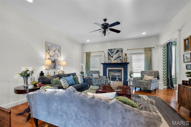 2528 Palomino Dr, Cape Girardeau, MO 63701 - living room featuring a ceiling fan, ornamental molding, wood finished floors, a glass covered fireplace, and recessed lighting