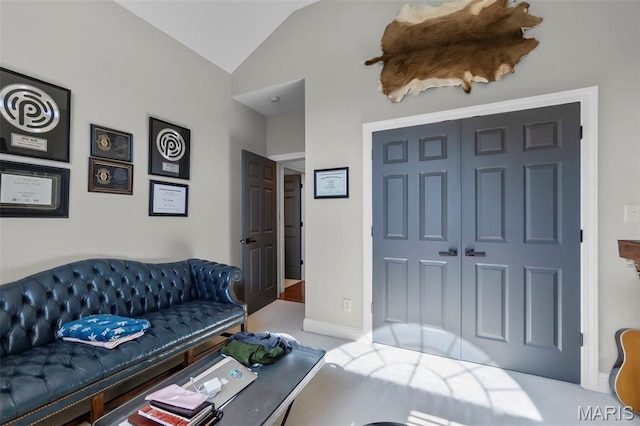 2528 Palomino Dr, Cape Girardeau, MO 63701 - carpeted living room featuring lofted ceiling and baseboards