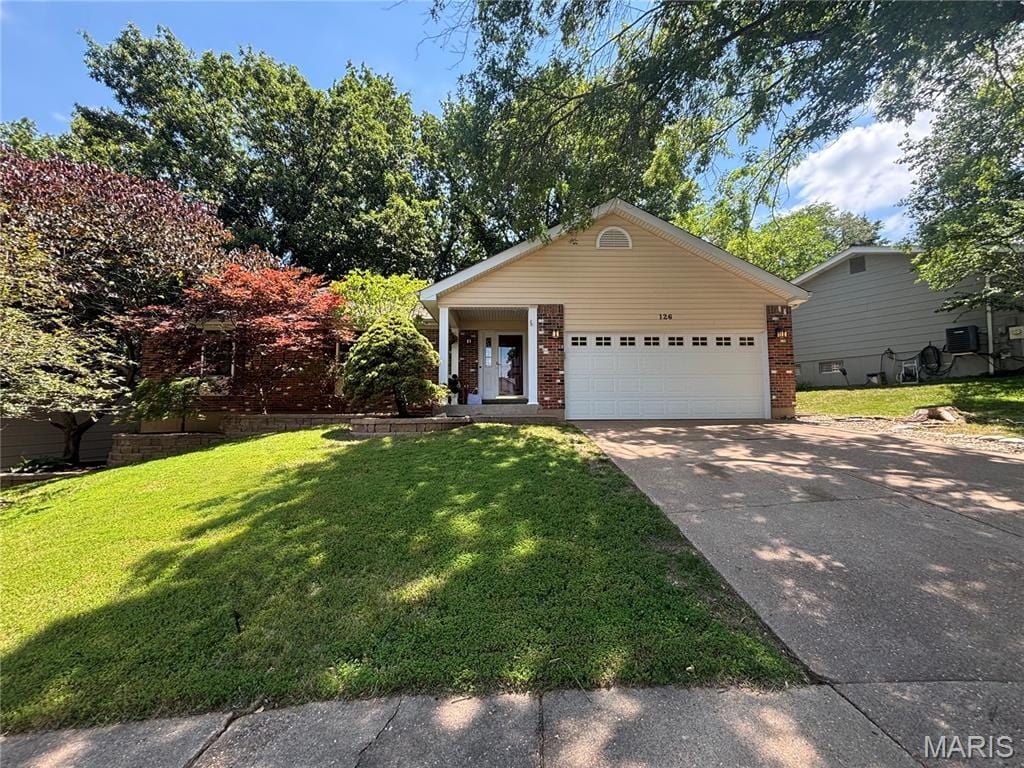 126 Asilomar Ct, Ballwin, MO 63021 - view of front facade with driveway, brick siding, a front lawn, and an attached garage