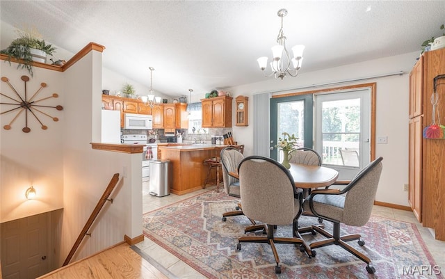 240 N Bernhardt Ave, Gerald, MO 63037 - dining room featuring a chandelier, lofted ceiling, a textured ceiling, and light tile patterned floors