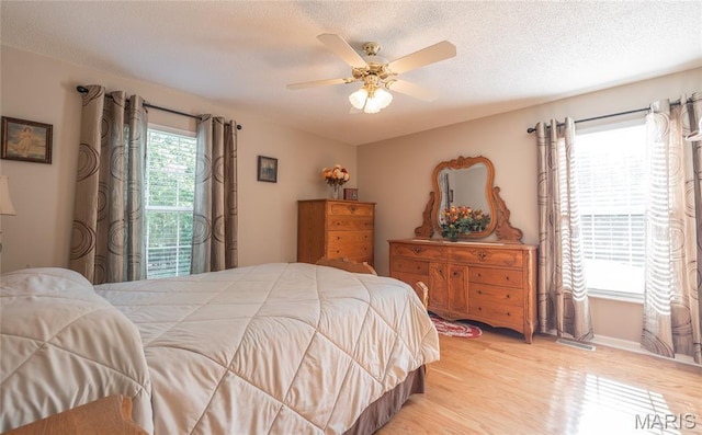 240 N Bernhardt Ave, Gerald, MO 63037 - bedroom with light wood-style flooring, a textured ceiling, access to exterior, and ceiling fan