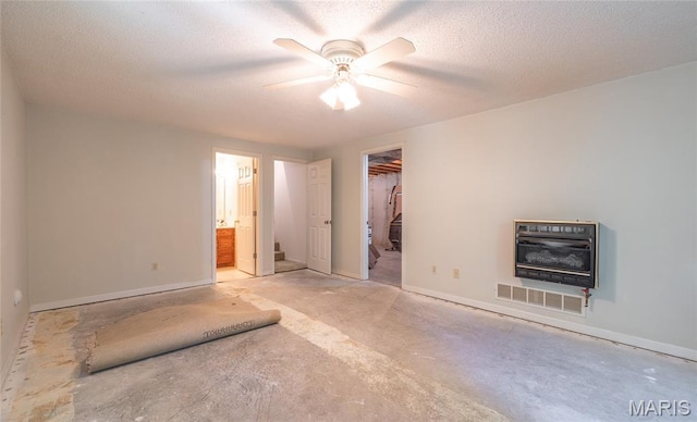 240 N Bernhardt Ave, Gerald, MO 63037 - unfurnished bedroom featuring heating unit, a walk in closet, ensuite bathroom, a textured ceiling, and a ceiling fan