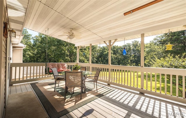 240 N Bernhardt Ave, Gerald, MO 63037 - wooden terrace featuring outdoor dining space, ceiling fan, view of wooded area, and a yard