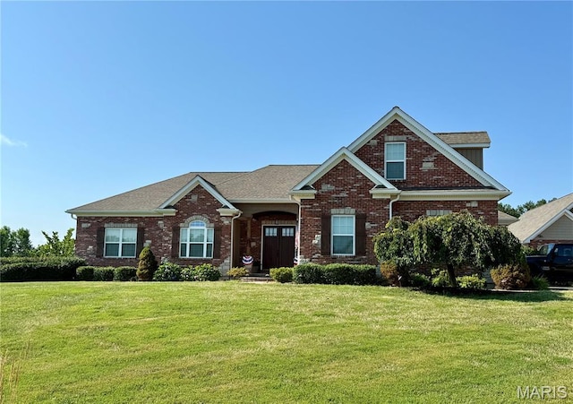 11078 Stonebridge Ln, Wentzville, MO 63385 - view of front of house featuring brick siding, a front lawn, and roof with shingles